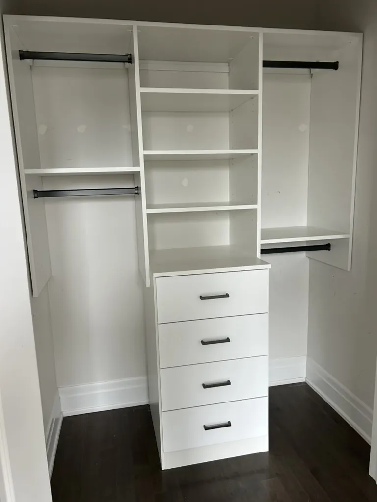 Custom walk-in closet with shelving and drawer tower by Newood Millwork