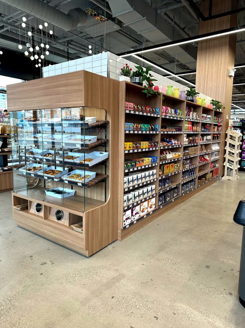 Custom retail display fixture with bakery case by Newood Millwork