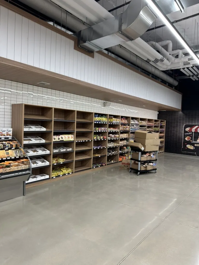 Custom retail shelving wall in a grocery market by Newood Millwork