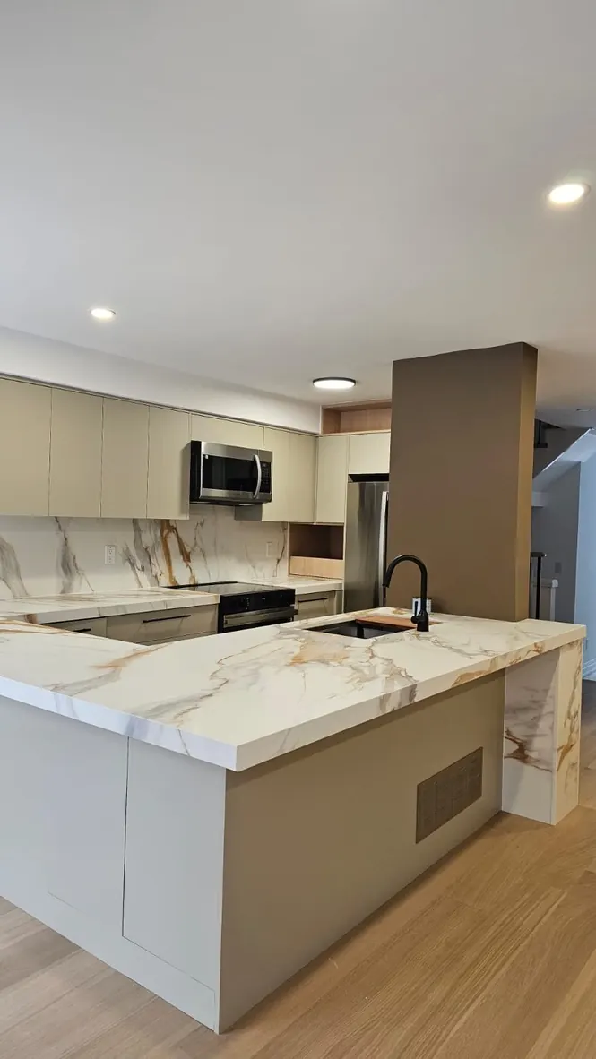 Custom kitchen island with waterfall stone countertop by Newood Millwork