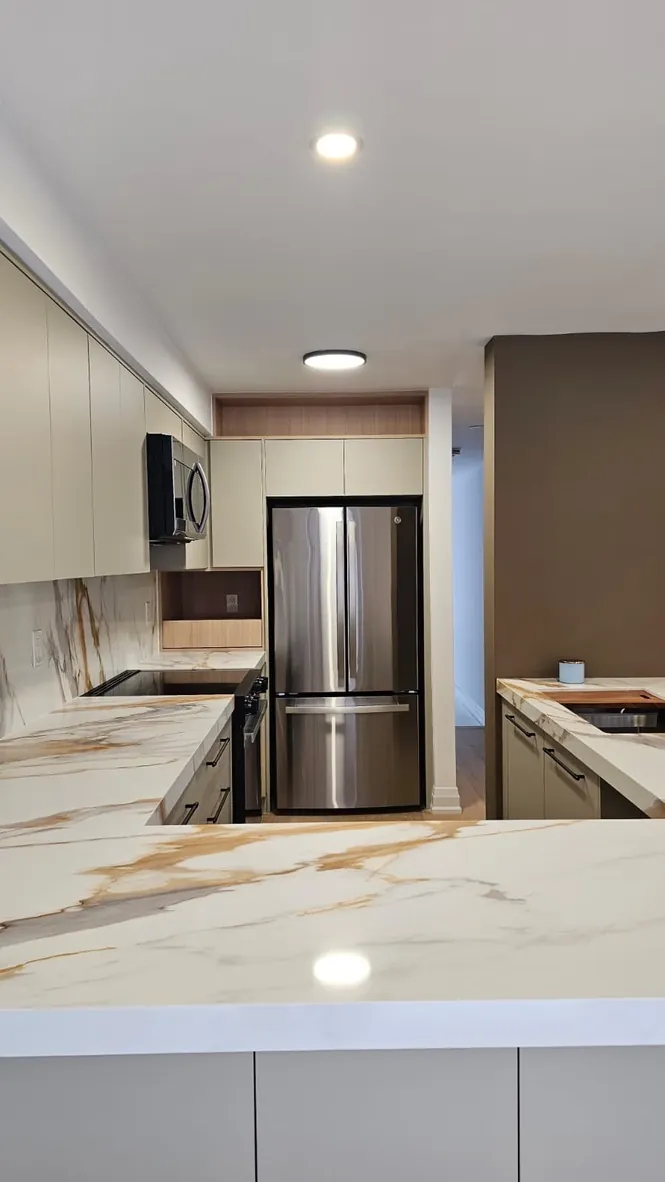 Custom kitchen cabinetry with integrated refrigerator by Newood Millwork