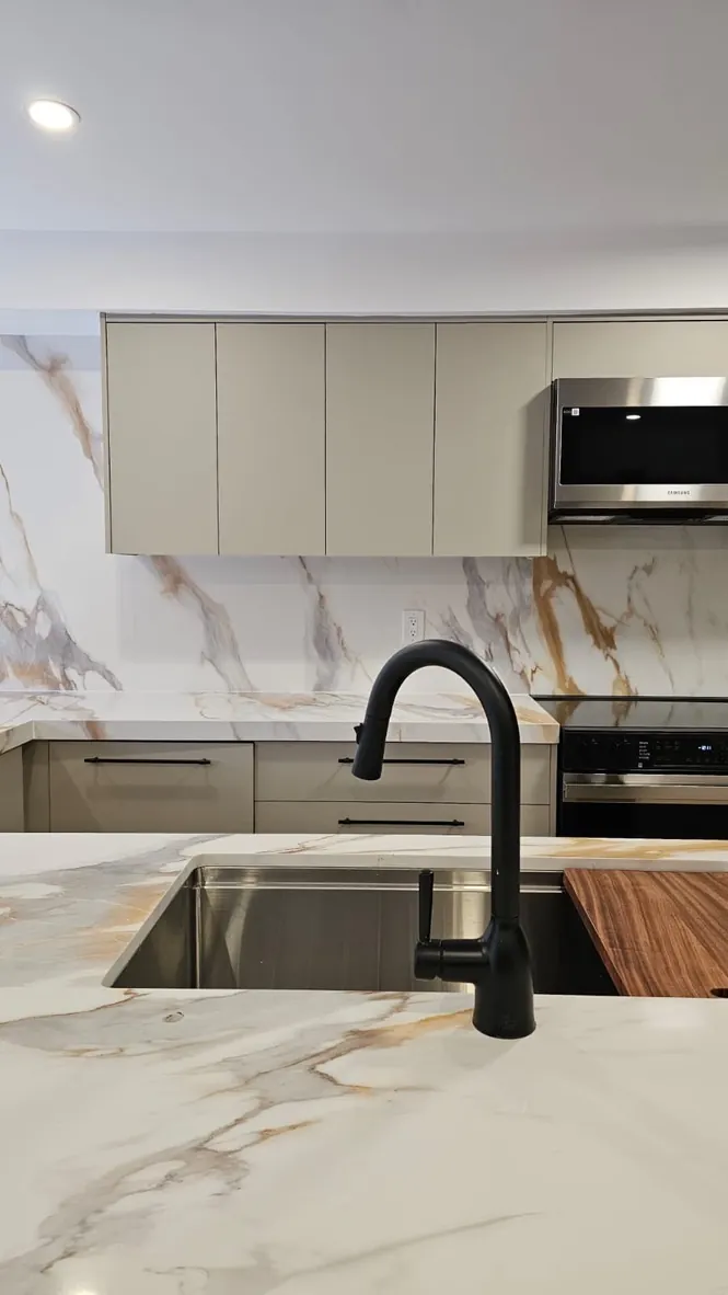 Kitchen island detail with matte black faucet by Newood Millwork