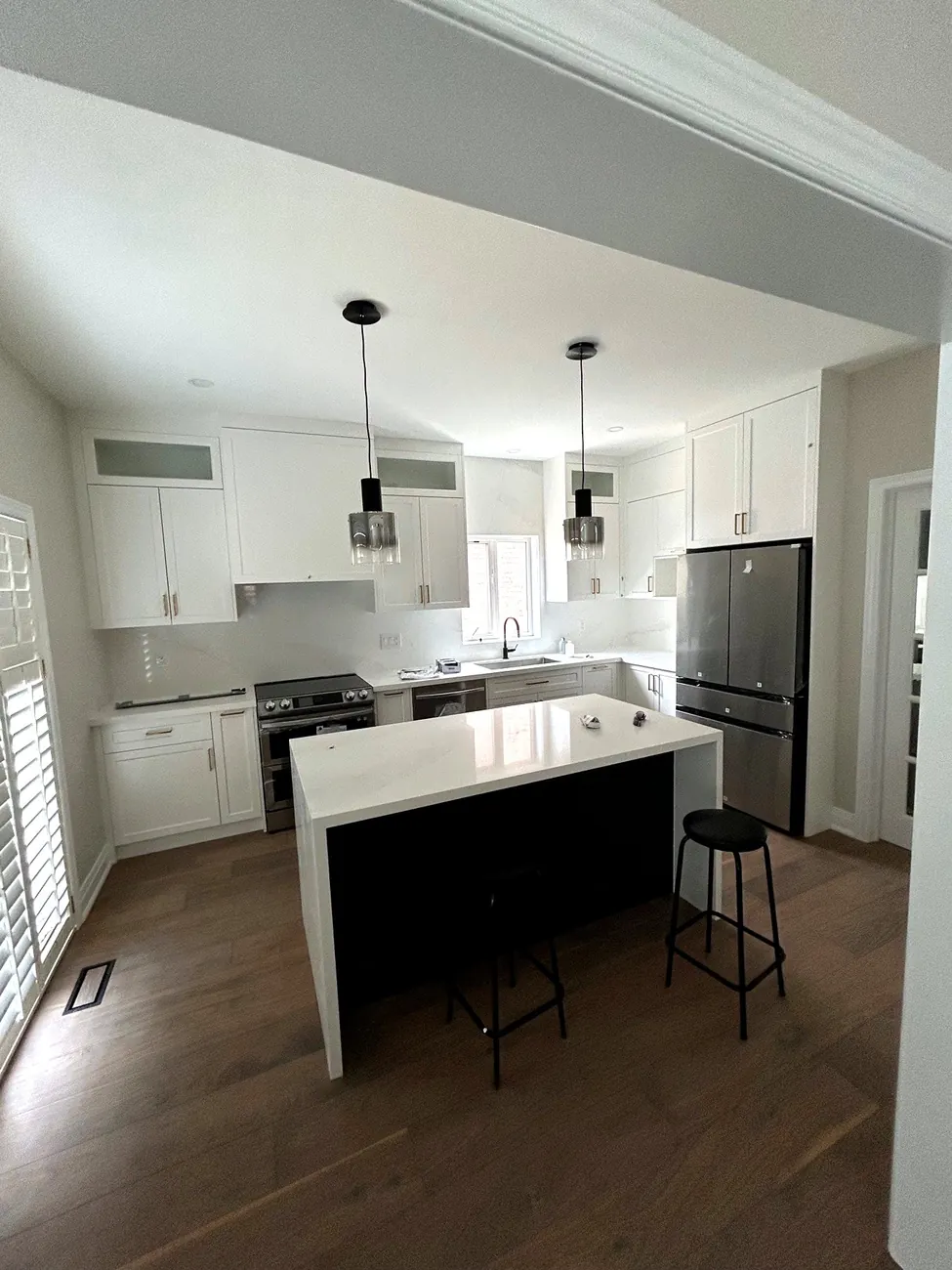 Custom kitchen renovation with waterfall island by Newood Millwork in Concord, Ontario